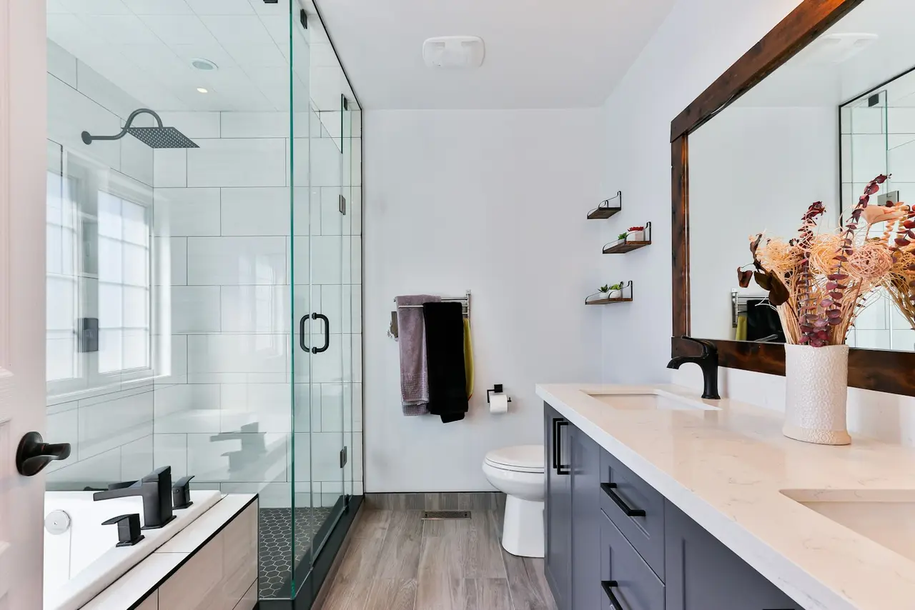 Bathroom with a shower enclosure and wall-mounted fittings